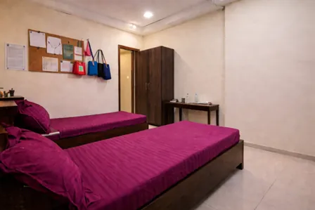 Comfortable executive triple sharing PG room in Andheri East offering ample storage and ergonomic design