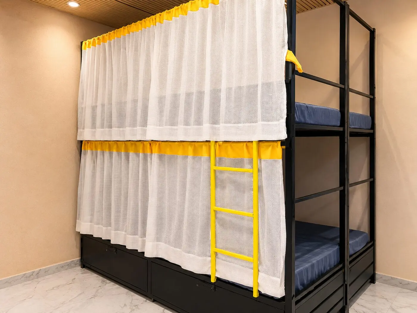 Curtained bunk beds with cushioned headboards at Zest Stays Goregaon West hostel